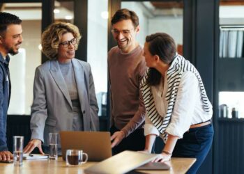 Group of business people having a meeting in a tech company. Creative business professionals planning a project in an office. Teamwork and collaboration in a modern workplace.