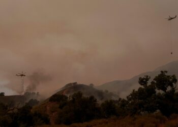 Torrid heat bakes millions of people in large swaths of US, setting records and fanning wildfires