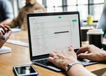 Person using a laptop during a meeting