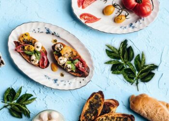 bruschetta, tomatoes, sprig of basil, seeded bread