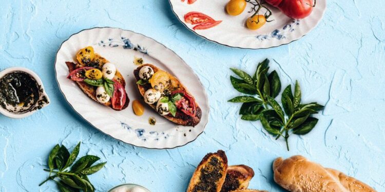 bruschetta, tomatoes, sprig of basil, seeded bread